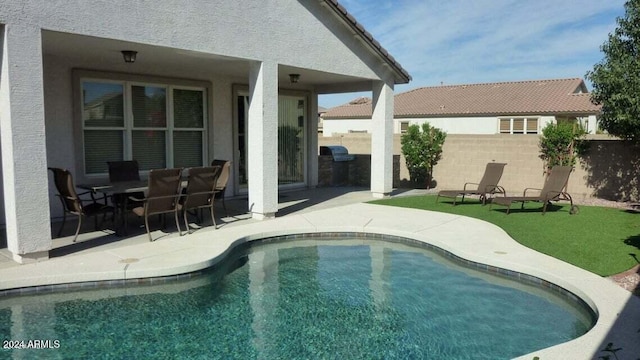 pool with a patio area and a fenced backyard