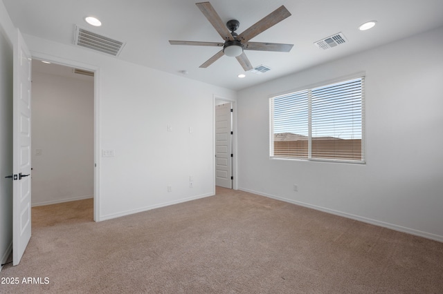 carpeted empty room featuring ceiling fan