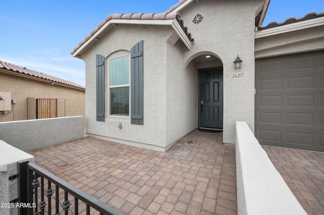 view of exterior entry featuring a garage