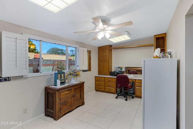 home office with baseboards, light tile patterned flooring, and a ceiling fan