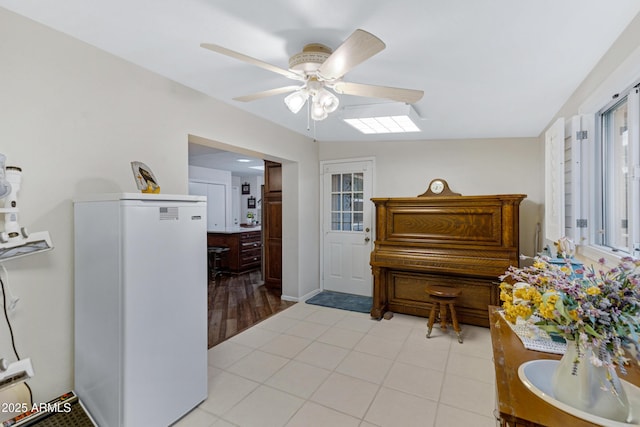 interior space with light tile patterned flooring and a ceiling fan