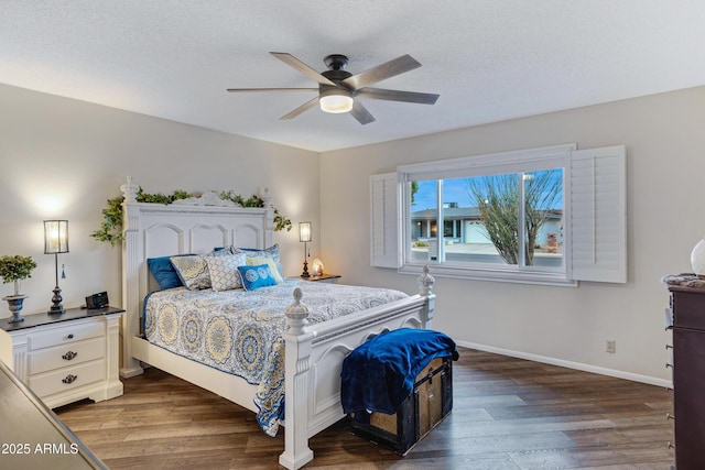 bedroom with ceiling fan, a textured ceiling, baseboards, and wood finished floors