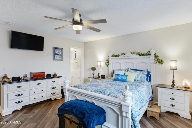 bedroom with dark wood finished floors, connected bathroom, a textured ceiling, and ceiling fan