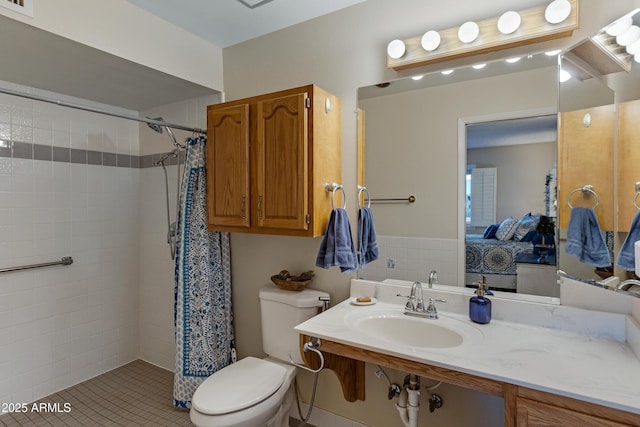 full bathroom with vanity, toilet, ensuite bathroom, and tiled shower