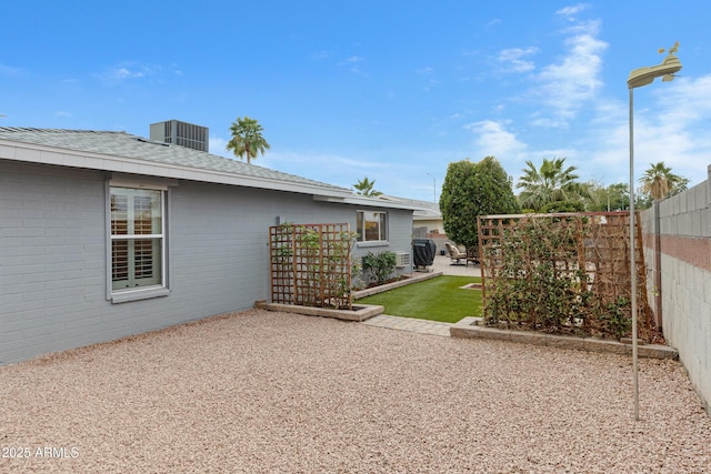 view of yard featuring cooling unit, a patio area, and a fenced backyard