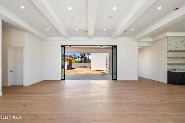 6202 E Larkspur Dr, Scottsdale, AZ 85254 - empty room with baseboards, beam ceiling, light wood-type flooring, recessed lighting, and a sink