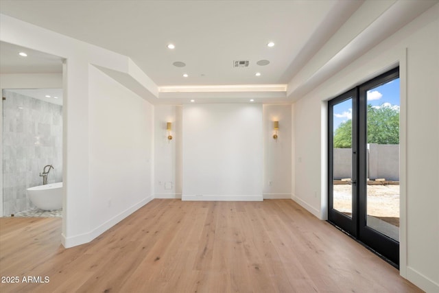 6202 E Larkspur Dr, Scottsdale, AZ 85254 - spare room featuring light wood-style floors, baseboards, recessed lighting, tile walls, and a raised ceiling
