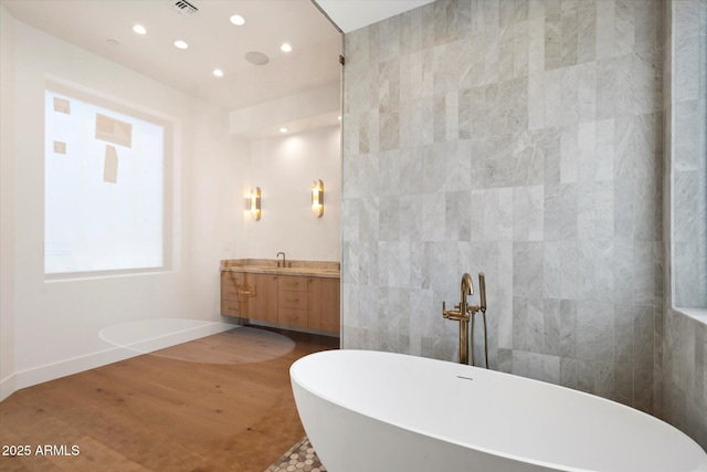 6202 E Larkspur Dr, Scottsdale, AZ 85254 - bathroom featuring a freestanding bath, vanity, recessed lighting, tile walls, and baseboards