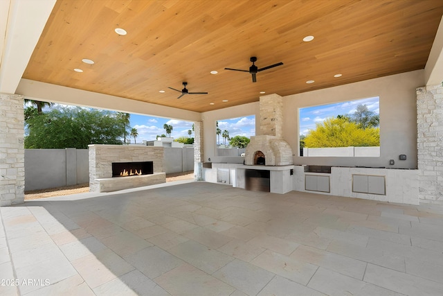 6202 E Larkspur Dr, Scottsdale, AZ 85254 - fenced backyard with an outdoor stone fireplace, exterior kitchen, and a patio area