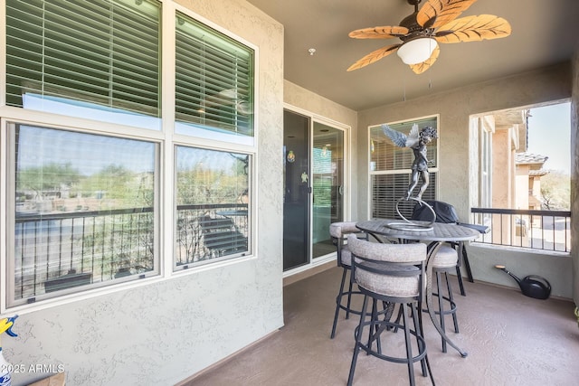 sunroom / solarium featuring ceiling fan