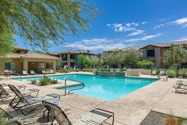 pool featuring a patio and fence