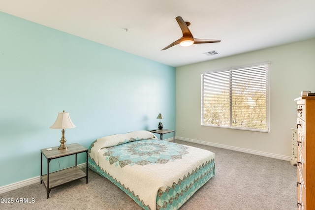 carpeted bedroom featuring baseboards, visible vents, and ceiling fan