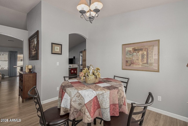 dining room with light hardwood / wood-style flooring and a notable chandelier