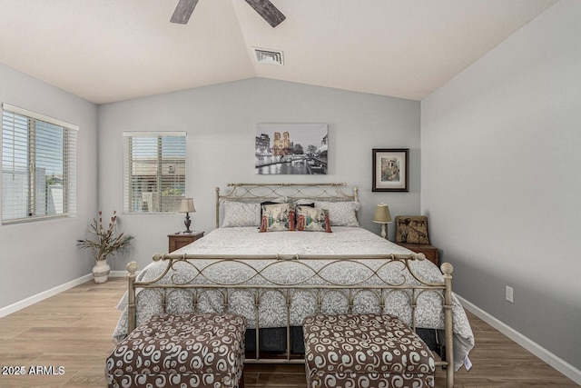 bedroom with wood-type flooring, ceiling fan, and lofted ceiling