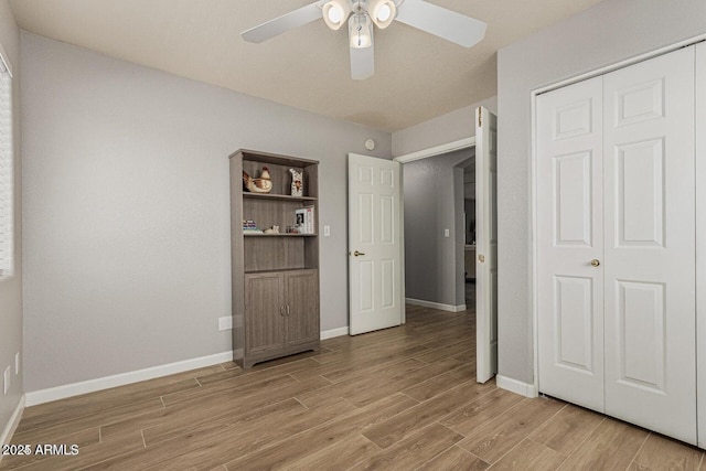 unfurnished bedroom featuring a closet, ceiling fan, and light hardwood / wood-style floors