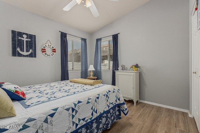 bedroom featuring wood-type flooring, ceiling fan, and lofted ceiling