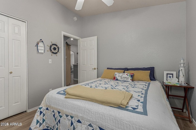 bedroom with ceiling fan, wood-type flooring, and a closet