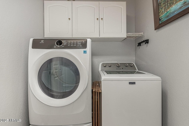 laundry area with cabinets and independent washer and dryer