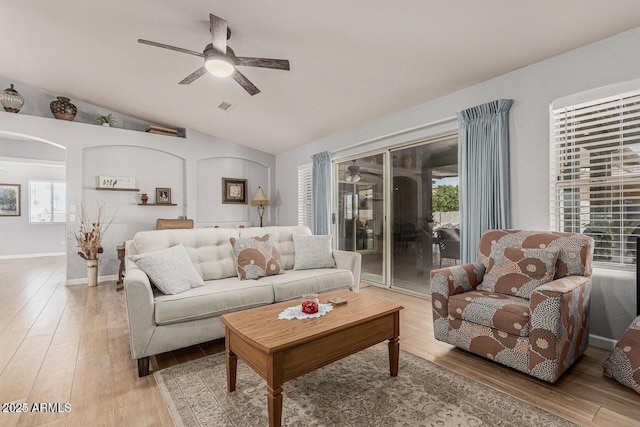 living room featuring wood-type flooring, ceiling fan, and lofted ceiling