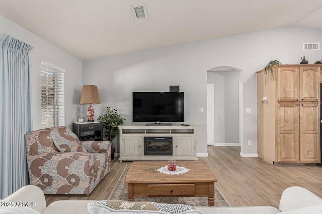 living room with lofted ceiling and light wood-type flooring