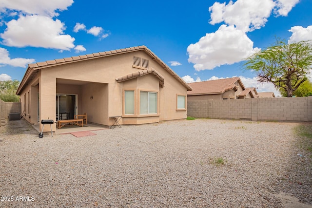 12371 W Hadley St, Avondale, AZ 85323 - rear view of property featuring a tile roof, fence, a patio, and stucco siding
