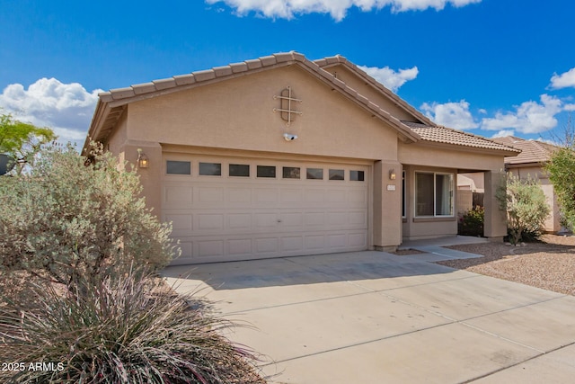 12371 W Hadley St, Avondale, AZ 85323 - view of front of property with a tiled roof, a garage, stucco siding, and concrete driveway