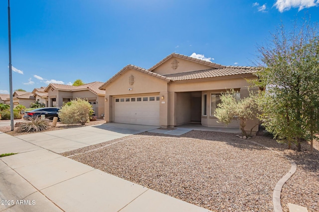 12371 W Hadley St, Avondale, AZ 85323 - mediterranean / spanish-style house with a garage, stucco siding, driveway, and a tile roof