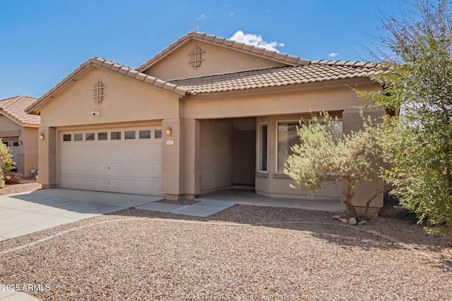 12371 W Hadley St, Avondale, AZ 85323 - mediterranean / spanish-style house with a tile roof, an attached garage, driveway, and stucco siding