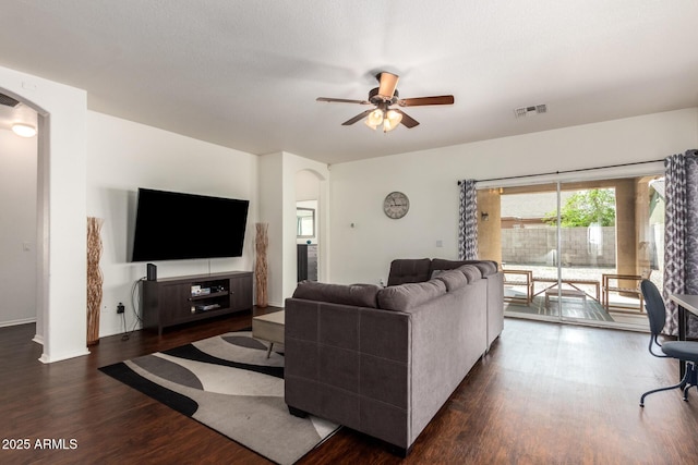 12371 W Hadley St, Avondale, AZ 85323 - living room with dark wood-style flooring, baseboards, visible vents, ceiling fan, and arched walkways