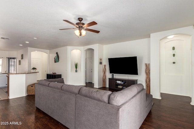 12371 W Hadley St, Avondale, AZ 85323 - living area featuring dark wood-type flooring, visible vents, ceiling fan, and arched walkways