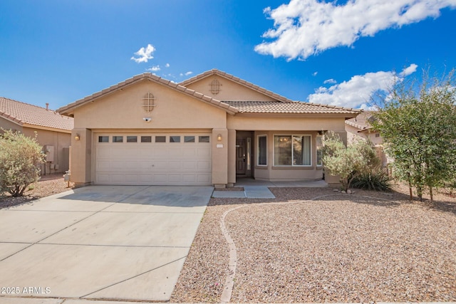 12371 W Hadley St, Avondale, AZ 85323 - view of front of property featuring an attached garage, driveway, stucco siding, and a tile roof