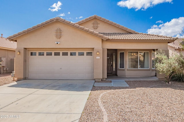 12371 W Hadley St, Avondale, AZ 85323 - view of front of house with a tiled roof, an attached garage, driveway, and stucco siding
