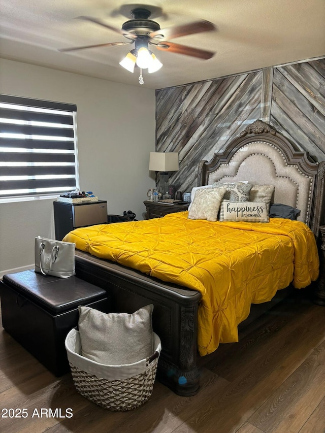 bedroom with ceiling fan and hardwood / wood-style flooring