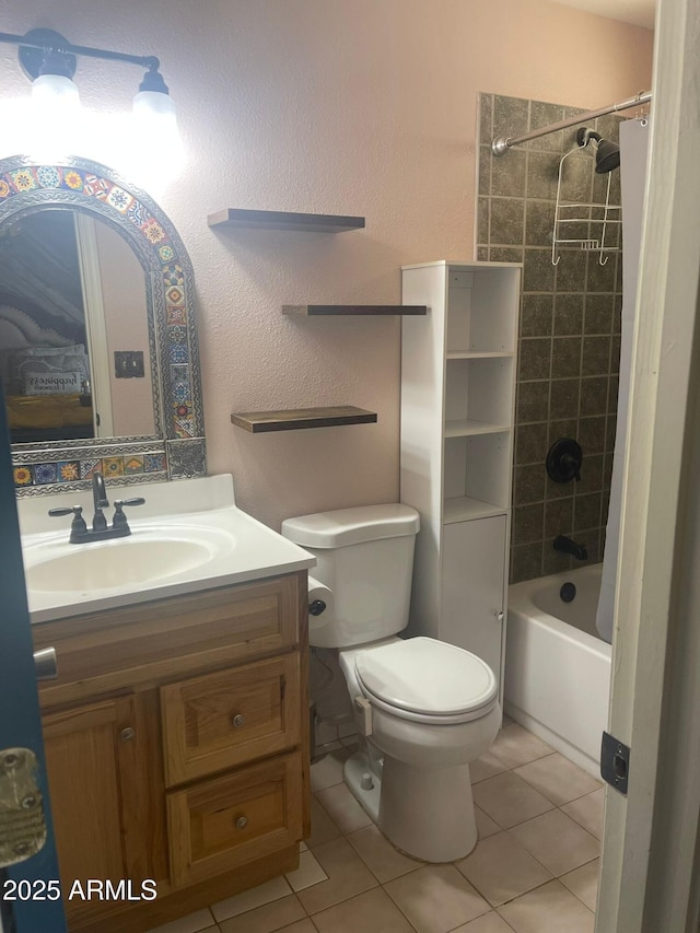 full bathroom featuring toilet, tiled shower / bath combo, tile patterned flooring, and vanity