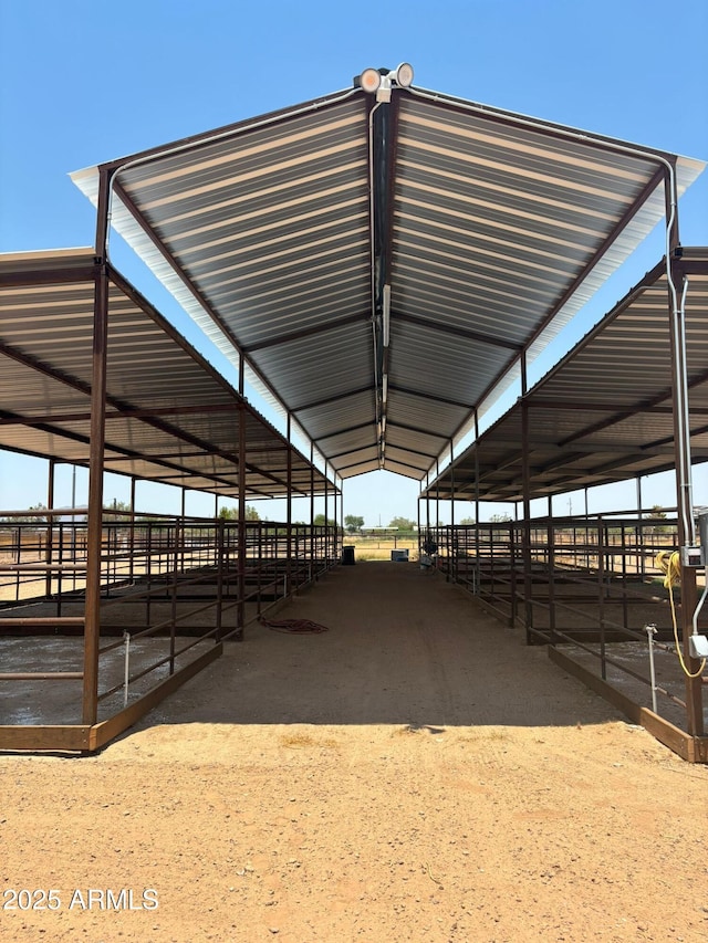 view of horse barn featuring a rural view
