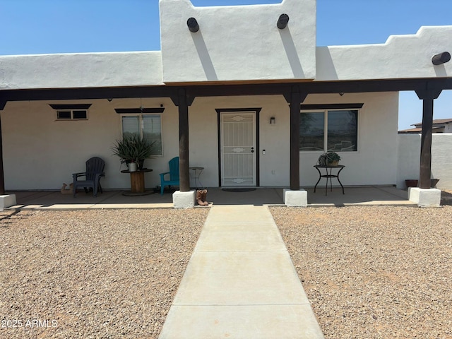 entrance to property featuring a patio