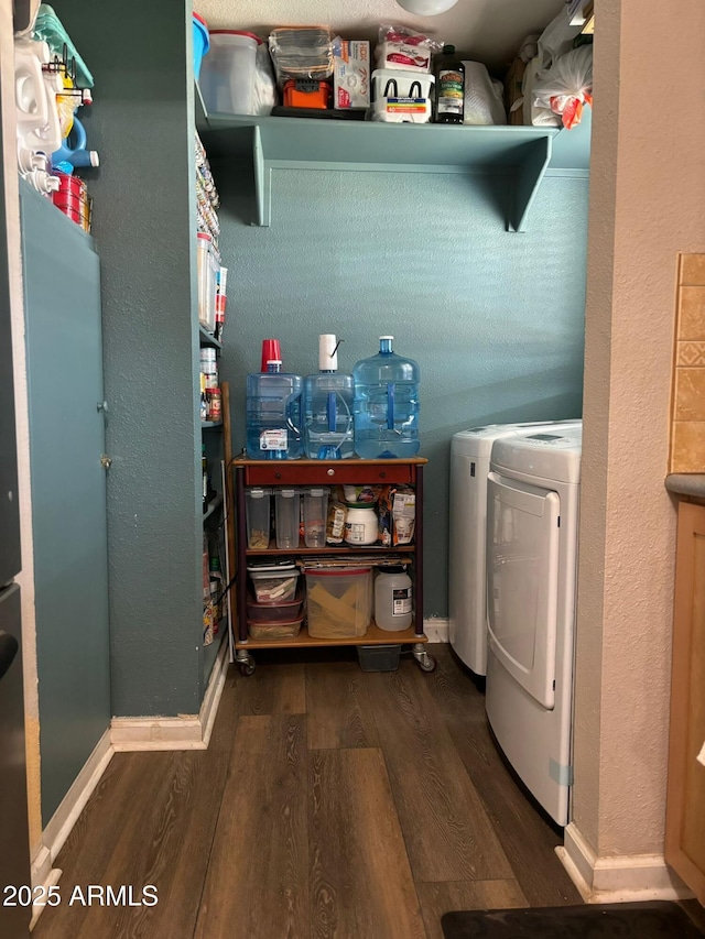 washroom with separate washer and dryer and dark hardwood / wood-style flooring