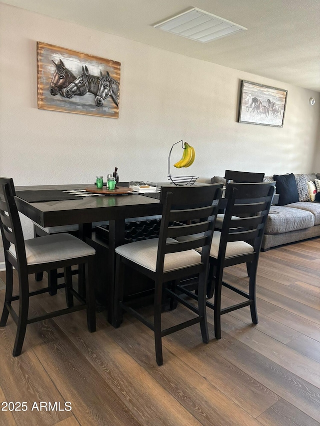 dining area featuring hardwood / wood-style floors