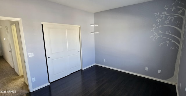 unfurnished bedroom with dark wood-style floors and baseboards