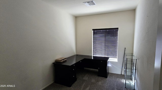 home office with visible vents and dark carpet