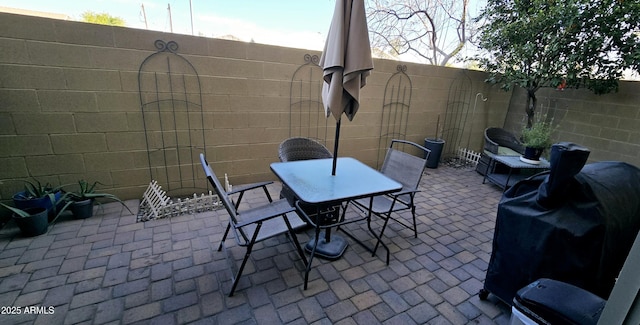 view of patio / terrace with outdoor dining area, grilling area, and a fenced backyard