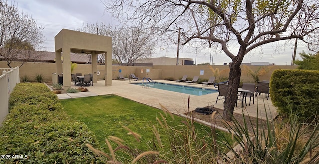 pool with a fenced backyard and a patio