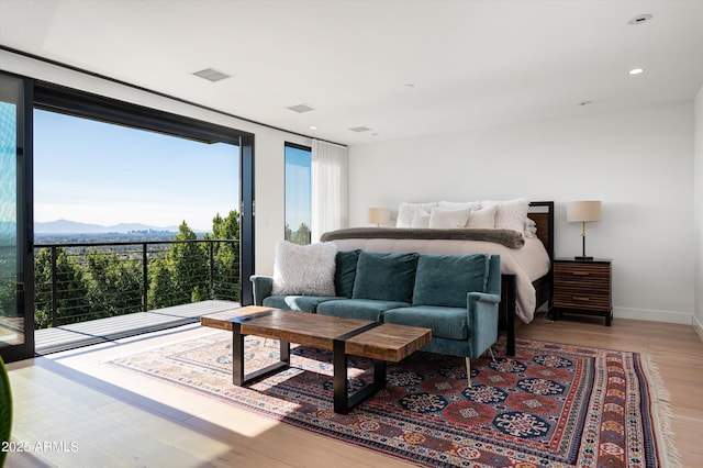 bedroom featuring a mountain view and light hardwood / wood-style floors