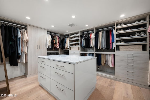 walk in closet featuring light hardwood / wood-style flooring