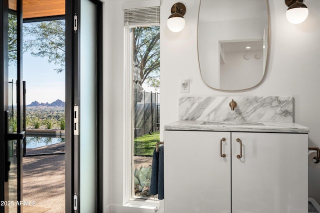 interior details featuring vanity and a water and mountain view