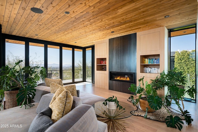 living room with built in features, wooden ceiling, and expansive windows