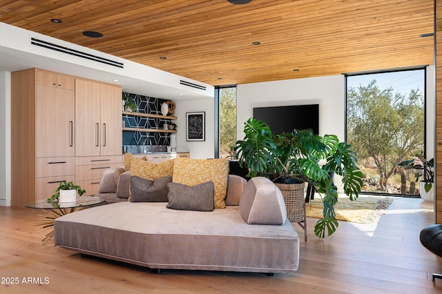 living room with a wall of windows, wooden ceiling, and light hardwood / wood-style floors