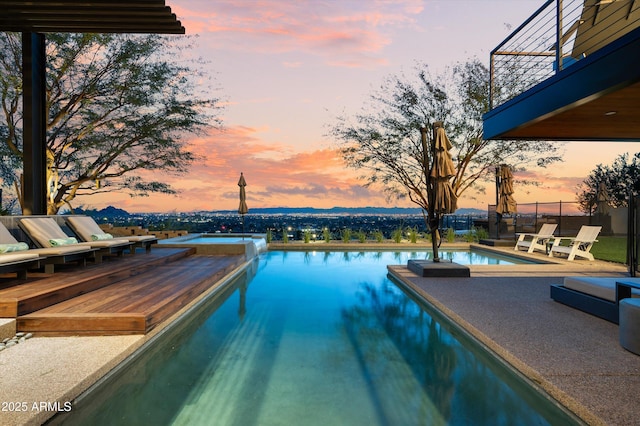 view of pool at dusk