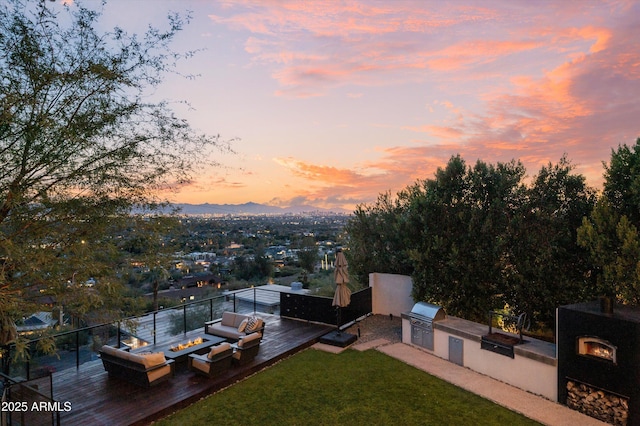 exterior space with a yard, outdoor lounge area, a grill, area for grilling, and a mountain view