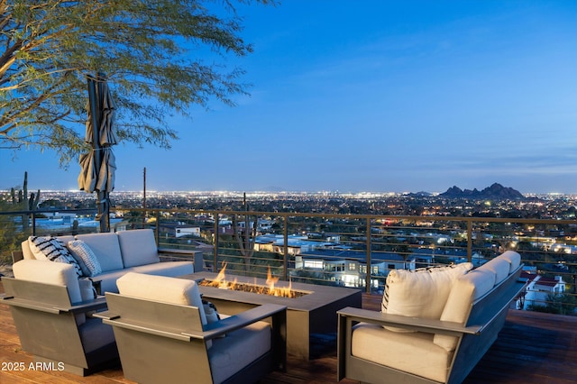 patio terrace at dusk featuring an outdoor living space with a fire pit